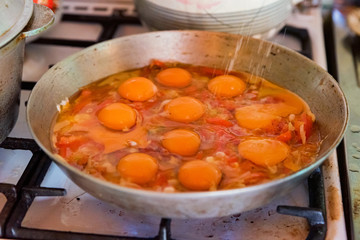 Cooking fried eggs on frying pan close up