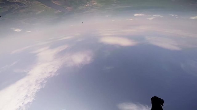 Skydivers jump from airplane. Make formation in blue sky. Extreme sport. Sunny. Professionals