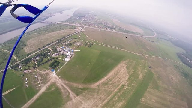 Skydivers jump from airplane. Make formation in blue sky. Extreme sport. Sunny. Professionals