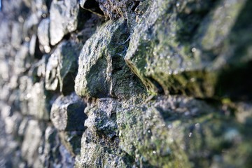 Stone wall glints in sunlight
