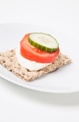 Crispbread with tomato and cucumber slice and cheese
