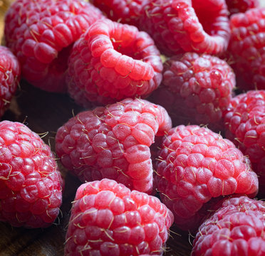 Close up of a pile of freshly washed raspberries. Fresh, healthy food, lifestyle. Macro photo