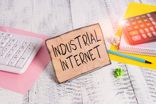 Text sign showing Industrial Internet. Business photo showcasing use of the internet of things in industrial sectors Notepaper stand on buffer wire in between computer keyboard and math sheets