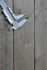 calipers on wooden background. copy space