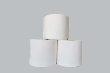 Stacks of rolls of toilet paper on white background