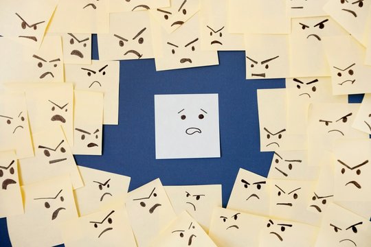 Sticky notes with anthropomorphic face blaming colleague