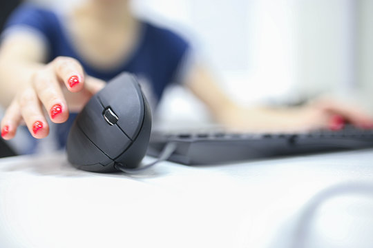 Girl's Hand Uses A Vertical Ergonomic Computer Mouse Joystick.