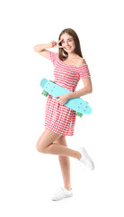 Stylish hipster girl with skateboard showing victory gesture on white background