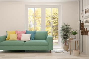 Stylish room in white color with sofa and autumn landscape in window. Scandinavian interior design. 3D illustration