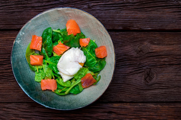 Top view plate with salmon salad with poached egg