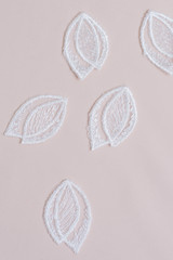 Texture lace fabric. lace on white background studio. thin fabric made of yarn or thread. a background image of ivory-colored lace cloth. White lace on beige background.