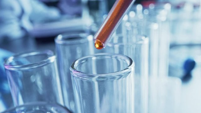 Pharmaceutics Laboratory: Pipette Dropping Red / Orange Liquid into Test Tubes, Medical Research, Analysis