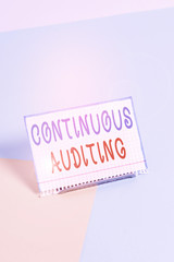 Text sign showing Continuous Auditing. Business photo showcasing Internal process that examines accounting practices Paper placed tilted above buffer wire on soft pastel multi colours backdrop