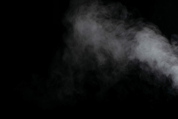 Beautiful puffs of white smoke randomly mixing slowly fill the blackness of the frame