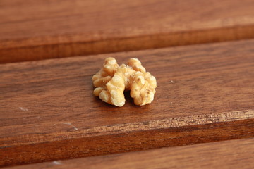 Peeled walnuts on wooden background