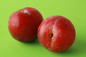 Delicious plums in colorful background