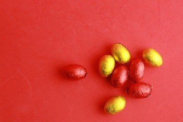 chocolate easter eggs, wrapped in yellow and red paper