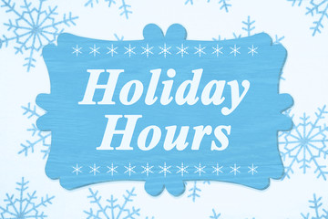 Holiday Hours message on a wood sign