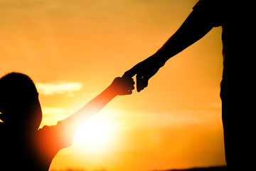 happy dad with a child in the park outdoors silhouette