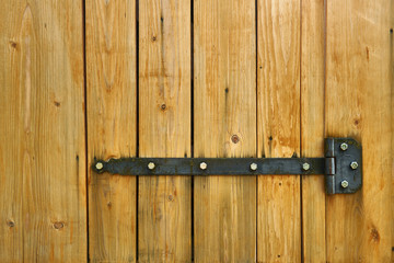 Iron latch and yellow wooden gate closeup on the ranch house for background or texture