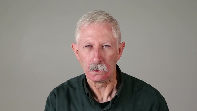 Grumpy old man with smoking ears