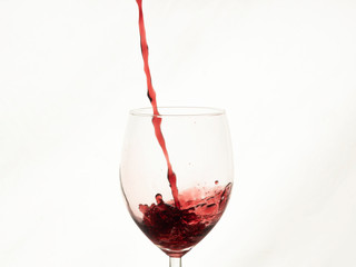 Close up of red wine splashing in a glass