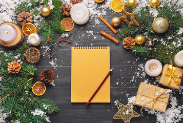 Christmas composition with notebook on wooden background