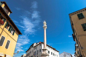 The medieval column with sculpture called Madonna of Stellario located in old town of Lucca, Italy - 310291382