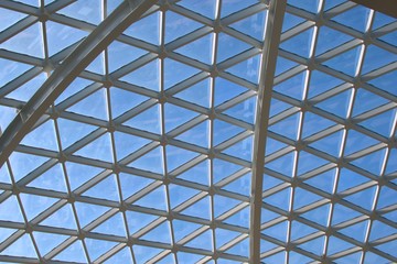 Fototapeta premium Large, modern design glass skylight at an airport. The beams form triangular patterns.