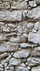 Very old stone wall, close-up architectural texture
