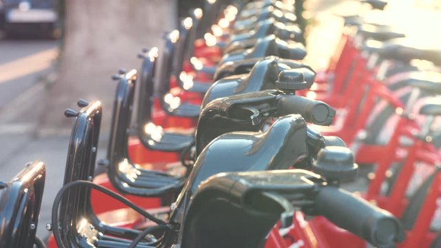 BARCELONA, SPAIN - 25 JANUARY 2019: Row of red bicycles in a bike rack, available for rental on the streets of Barcelona, sharing eco transportation, rent and ride tourist red bikes