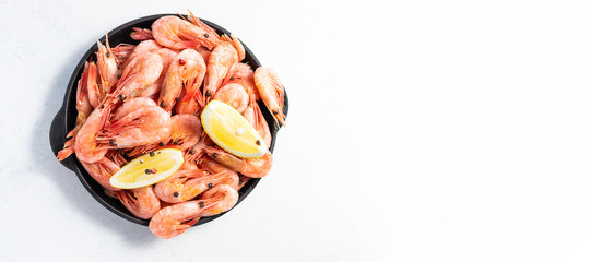 Long wide banner fresh boiled shrimps with spices on white background with copy space for your design. Template sea food restaurant menu.