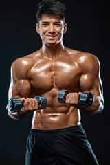 Fototapeta na wymiar Athlete bodybuilder. Strong and fit man. Sporty muscular guy with dumbbells. Sport and fitness motivation. Individual sports recreation.