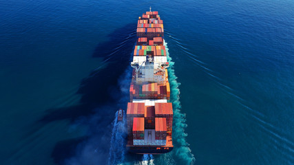 Aerial drone photo of industrial cargo container tanker ship carrier cruising the open ocean deep...