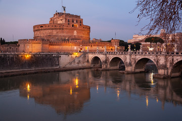 Night view of the bridge Sant'Angelo through the Tiber River and medieval Castle in city center of...