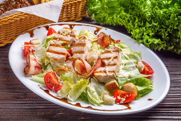 Caesar salad on dark wooden rustic background