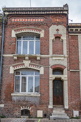 Fototapeta na wymiar Beautiful old brick houses in Amiens old town. Amiens - city and commune in northern France, 120 km north of Paris, capital of Somme department, Hauts-de-France.