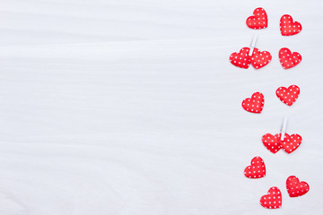 Valentine's day background. Red hearts on white wooden background. Valentines Day, love, wedding concept. Flat lay, top view.