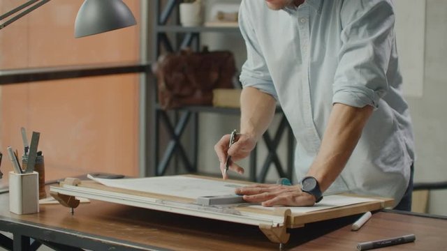 Concept architects,engineer holding pen pointing equipment architects On the desk with a blueprint in the office, Vintage, Sunset light. Close Up Of A Draftsman Drawing Diagram On Blueprints.