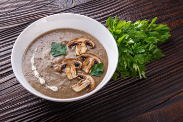 mushroom cream soup on rustic wooden background