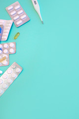 Tablets Vitamin pills and antibiotics on a colored background. Treating seasonal allergies, flu, and illness.