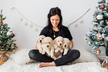 Lady Holding Golden Retriever Puppies