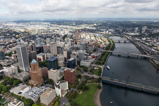 Aerial View Of The Williamette River, Buildings, Bridges And Streets In Downtown Portland, Oregon, USA.