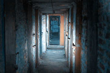 Fototapeta na wymiar Basement long corridor with old rusty metal doors