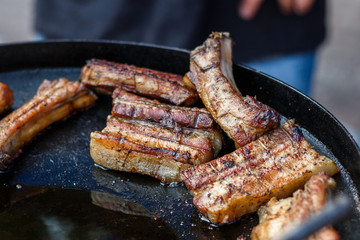 chef cooks ribs at the street food festival