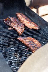 chef cooks ribs at the street food festival
