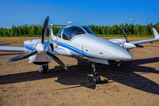 Four-seat light all-metal twin engine propeller-driven utility and trainer aircraft Diamond DA-42-VI Twin Star OH-DAB parked on Karhula aviation museum airshow. Kotka, Finland.