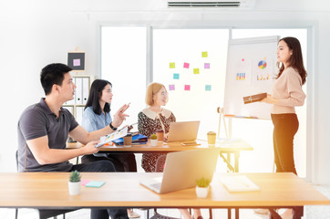 blurred asian team meeting and discussion about performance and result, asian man ask to presenter,  female officer present about organization business profit with her team, innovation and development