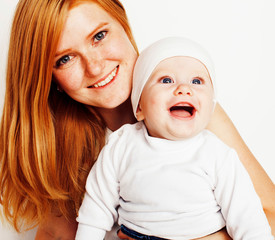 young beauty mother with cute baby, red head happy modern family smiling isolated on white background close up, lifestyle people concept