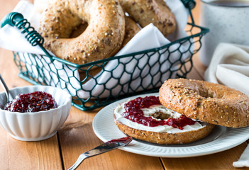 A close up of a bagel and cream cheese.